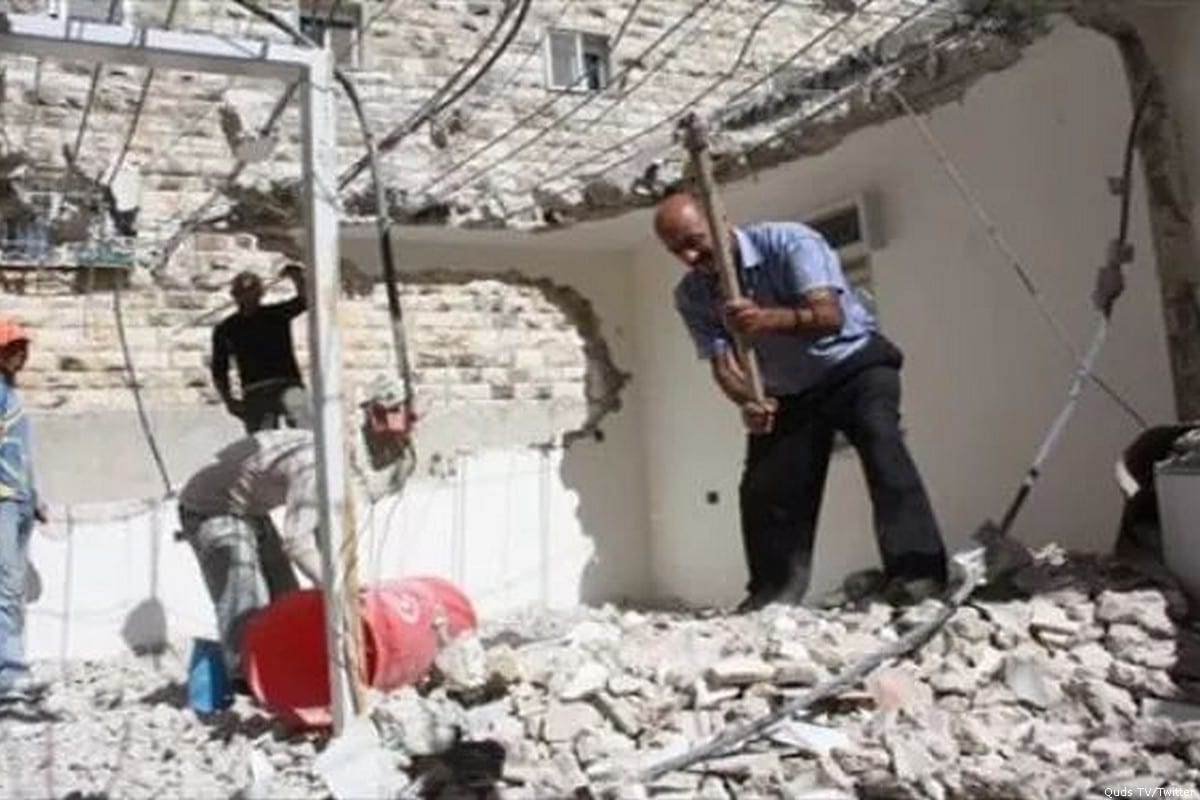 A Palestinian man can be seen demolishing his home on his wedding day after he was forced to do so by Israeli forces [Quds TV/Twitter]